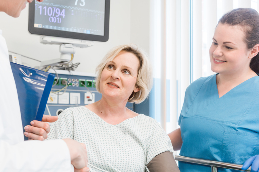 Patient and nurse speak with a physician