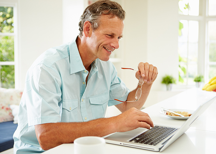 Smiling man with laptop