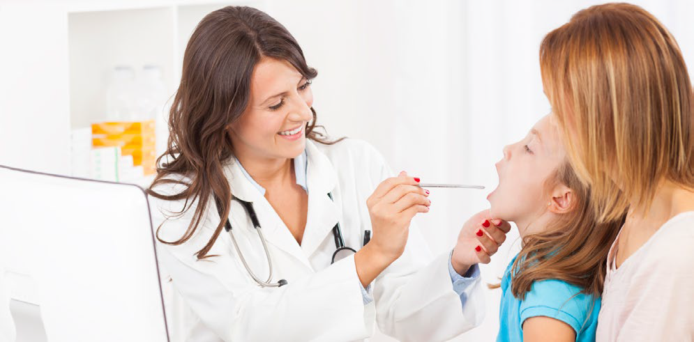 Physician performing a throat swab on a young patient