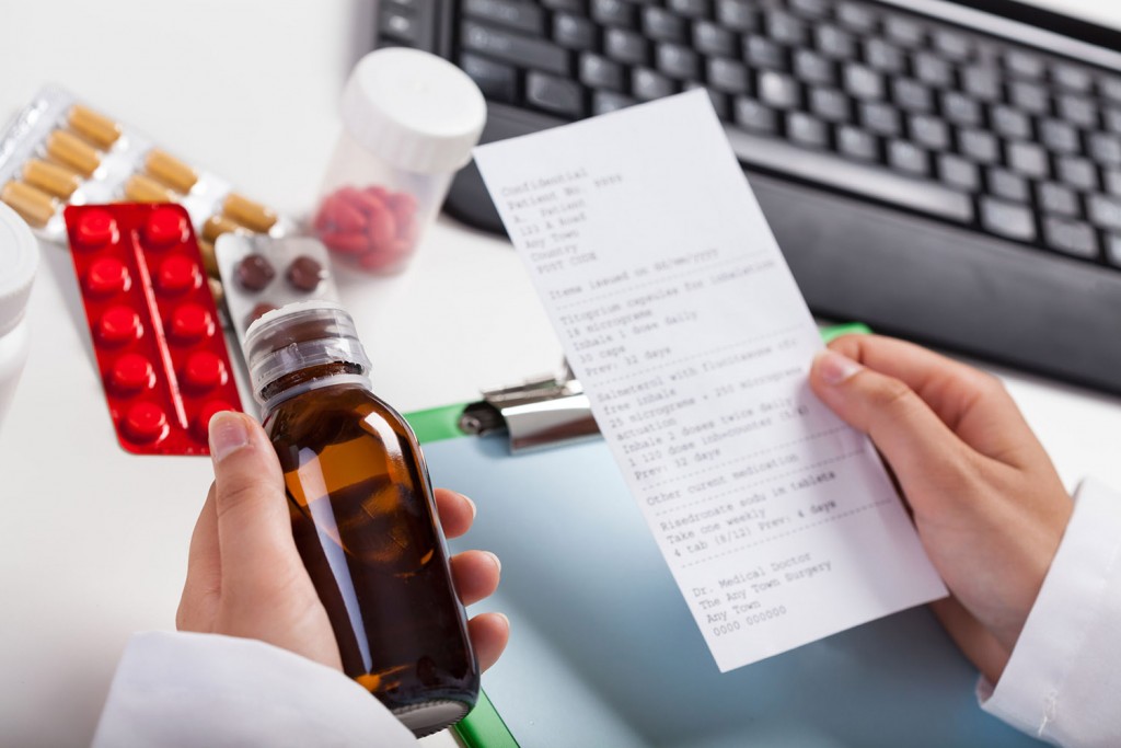 Pharmacist holding bottle of heartburn medication