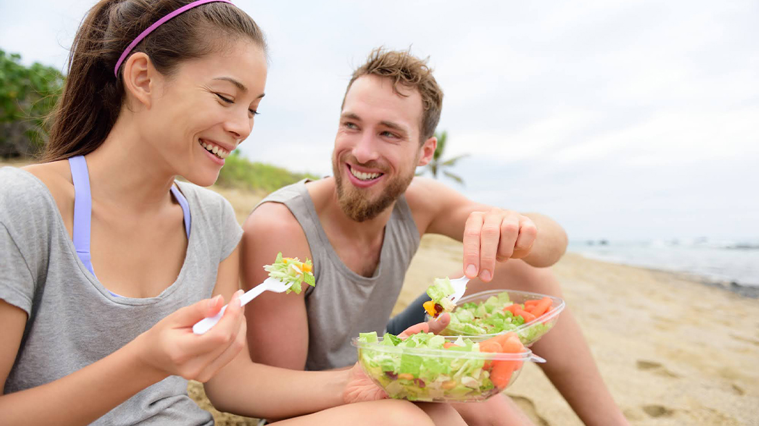 Woman enjoying a healthy snack on the beach