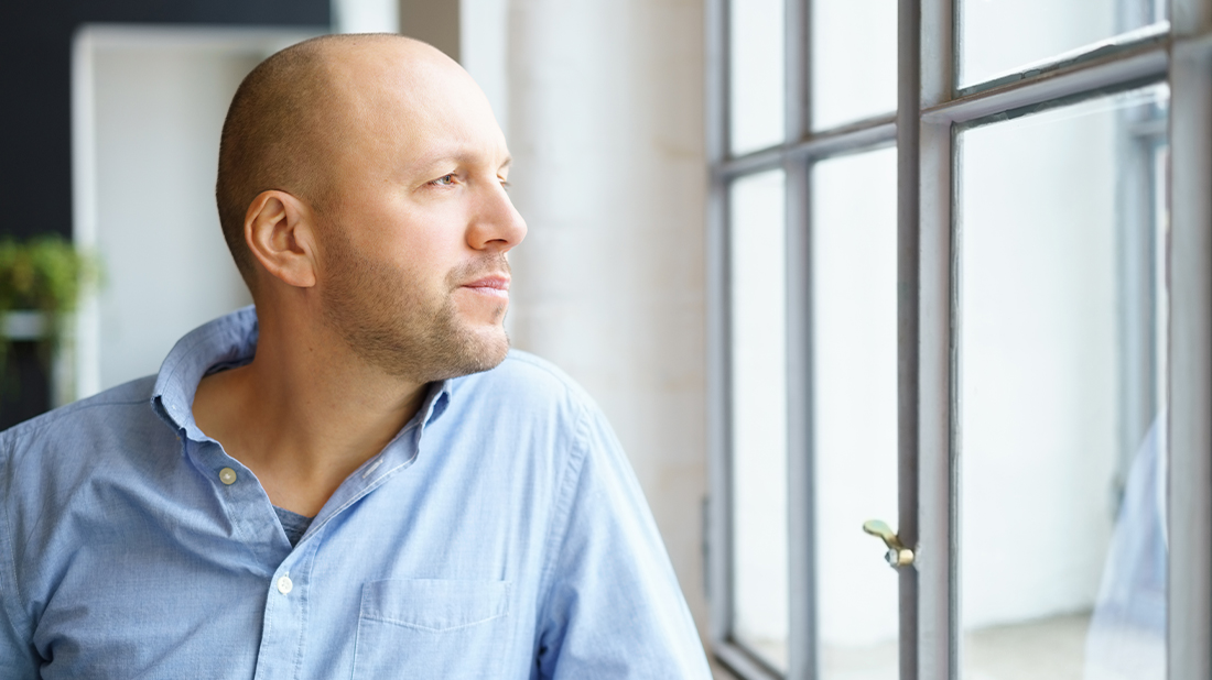 Man Looking Out Window